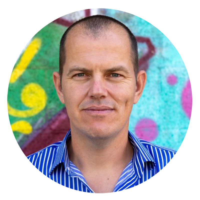 Man in blue striped shirt, colorful background.